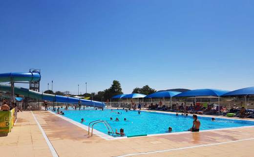 Piscine du côté du grand bassin avec le toboggan dans le fond à gauche